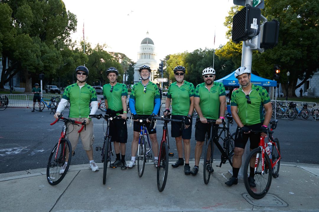 Group of riders in green jerseys