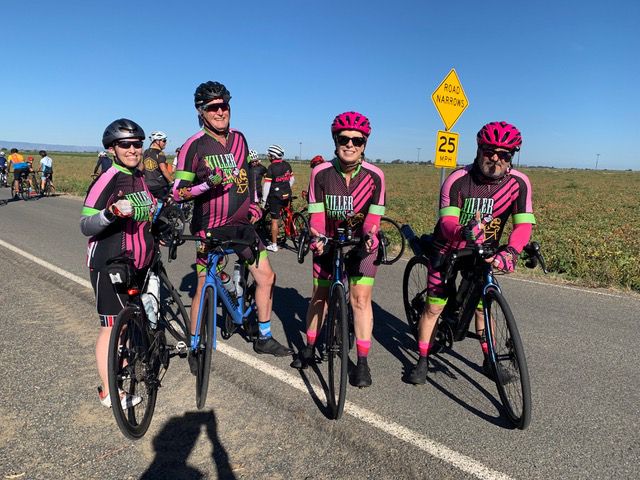 Group of riders in pink jerserys
